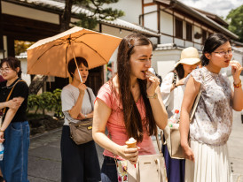 Candid shot of traveler and host chatting over lunch in Kyoto