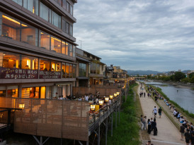 Traditional restaurant balconies overlooking the Kamogawa River with diners enjoying evening meals Photo by Transly Translation Agency on Unsplash