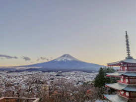 Snow-covered temple roofs in winter with Mount Fuji visible in the distance Photo by Maria Clarissa Badiola on Unsplash
