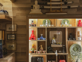 Traditional craft shop with ceramics on wooden shelves. Photo by Sergey Shulga on Unsplash