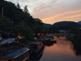 Locals relaxing by the Kamo River at sunset Photo by Merve Selcuk Simsek on Unsplash