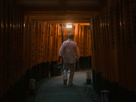 Person walking alone through a quiet temple gate Photo by Samielle Støyl on Unsplash