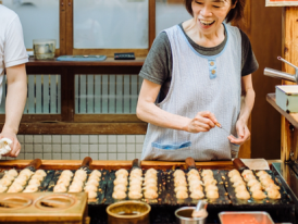 Takoyaki being prepared at a local street food stall.