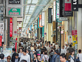 Busy Shinsaibashi shopping street with covered arcade.