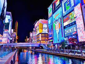 A vibrant, neon-lit street scene from Namba, capturing the energy of Osaka at night.