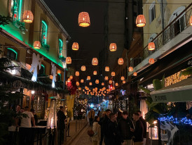 Nighttime shot of a food alley lit with paper lanterns Photo by Harry Kinigopoulos on Unsplash