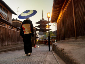 Dimly lit street with wooden facades and soft lantern light casting a warm glow over the historic Gion district