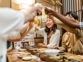 Friends eating at drinking at an Izakaya in Kyoto