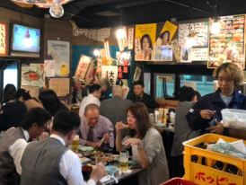 Locals eating at drinking at a traditional izakaya in Ueno