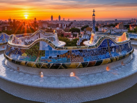 Mosaic serpentine bench at sunset with city skyline