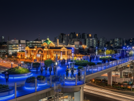 Seoullo 7017 elevated walkway lit up at night with pedestrians walking