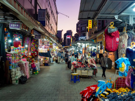 Vibrant street food stalls at Dongdaemun Night Market, bustling with late-night shoppers