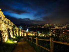 Night view from Naksan Park showcasing Seoul’s ancient fortress wall and city lights