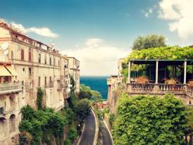 Residential street with sea view and hillside buildings
