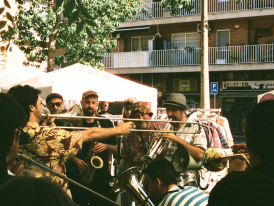 Crowded pedestrian boulevard with street musicians