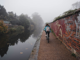 Cycling next to a canal in Dublin in misty weather