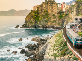 Blue local train traveling along the scenic Amalfi Coast route