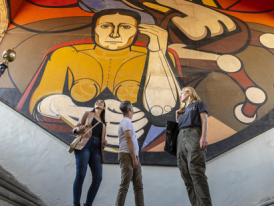 Visitors respectfully viewing wall murals