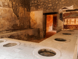 Empty frescoed room at Oplontis in the afternoon light