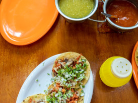 Tacos al pastor and a variety of salsas