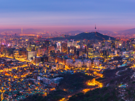 Seoul's glowing skyline at night with mix of traditional and modern architecture 