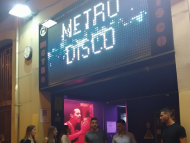 Vibrant Metro Disco club with people coming and going