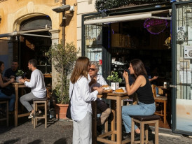 Locals standing at espresso bar in Sorrento with cornetti and sfogliatella pastries