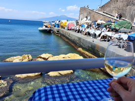 Waterfront view from Emilia Trattoria with a glass of refreshing white wine