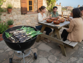rustic grill piled with calçots and romesco bowls