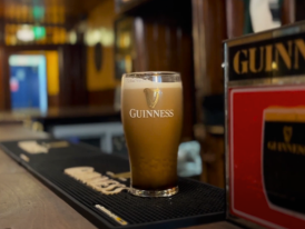 John Kavanagh pub with wood-paneled, cozy interior and a pint of Guiness