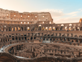 Inside the Colosseum at sunrise, tiers and hypogeum in view