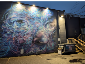 Street art mural in Main Street alley under streetlights