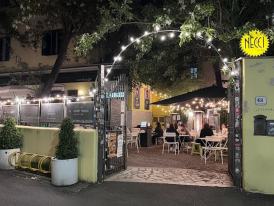 Necci dal 1924’s terrace with  string lights and diners