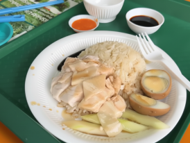 Delicious plate of chicken rice served with dark soy sauce