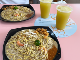 People enjoying local Hokkien mee at a heartland hawker center