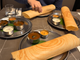 masala dosa and chutneys served on metal plate in Tooting
