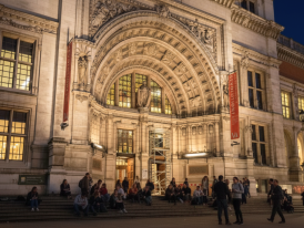 Late-night event poster and crowd at V&A entrance