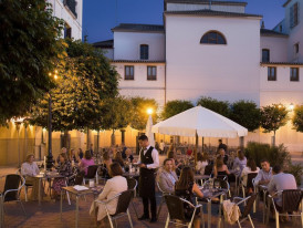 Evening street in Malasaña with terraces and locals chatting [Hero Image]