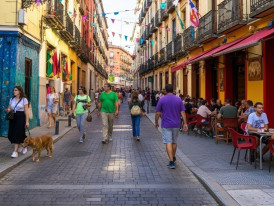 colorful Lavapiés street scene with multicultural restaurant signs