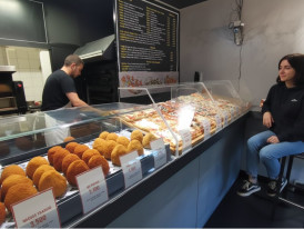 Street vendor preparing fresh arancini with crispy golden exterior