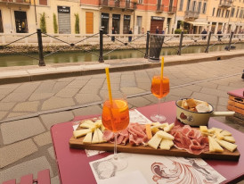 Canal-side dining along Navigli at sunset with outdoor seating