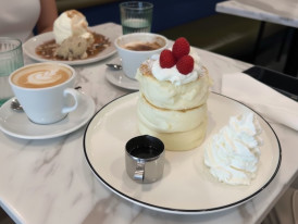 Japanese soufflé pancakes topped with whipped cream and fresh berries