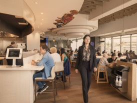 Bustling Vancouver restaurant interior with diners and servers