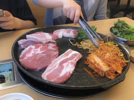 sizzling samgyeopsal on a hot grill