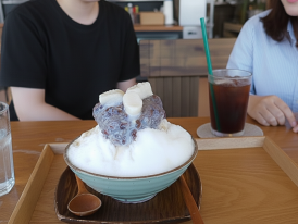 towering bingsu with red beans, rice cakes, and condensed milk drizzle