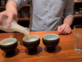 A bartender pouring makgeolli for a tasting