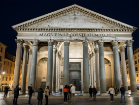 Pantheon portico illuminated at night with people silhouettes in foreground