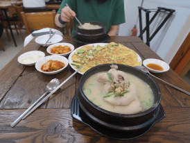 Clay bowl of samgyetang with ginseng, dates, and rice
