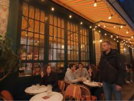 A Parisian brasserie or restaurant with outdoor seating at night, or a night-time street scene