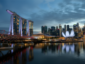 Singapore skyline at twilight with lights beginning to illuminate buildings
